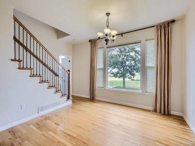 interior space with light hardwood / wood-style flooring and a notable chandelier