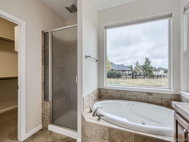 bathroom featuring shower with separate bathtub, tile patterned floors, and vanity