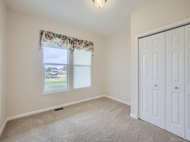 unfurnished bedroom featuring a closet and carpet floors