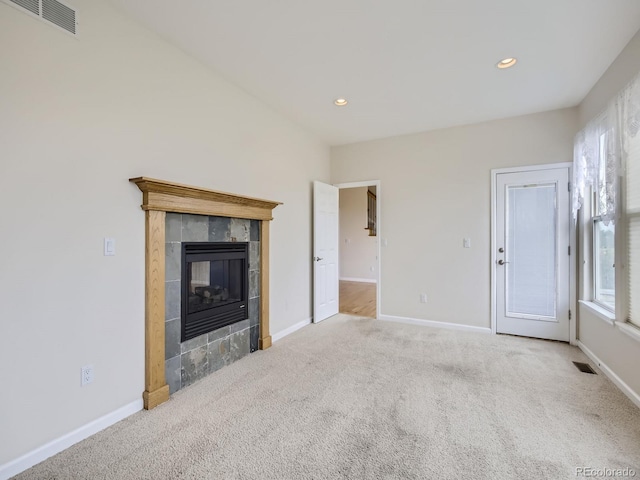 unfurnished living room featuring a fireplace and carpet floors