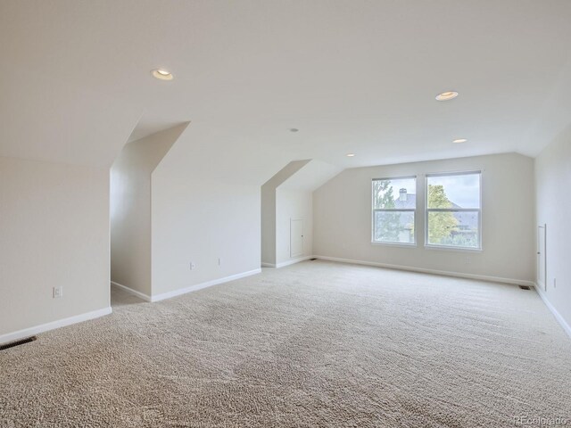 additional living space with lofted ceiling and light colored carpet