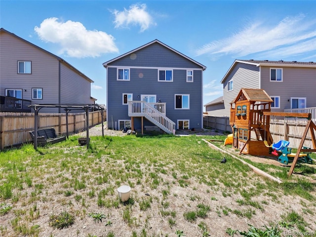 back of house with a playground and stairs