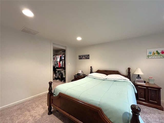 carpeted bedroom with visible vents, a walk in closet, recessed lighting, a closet, and baseboards