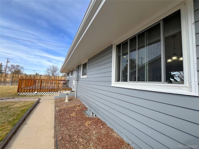 view of side of property featuring fence