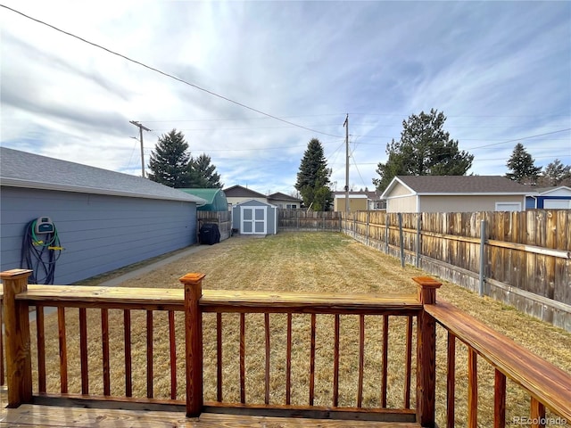 view of yard with an outbuilding, a fenced backyard, and a shed