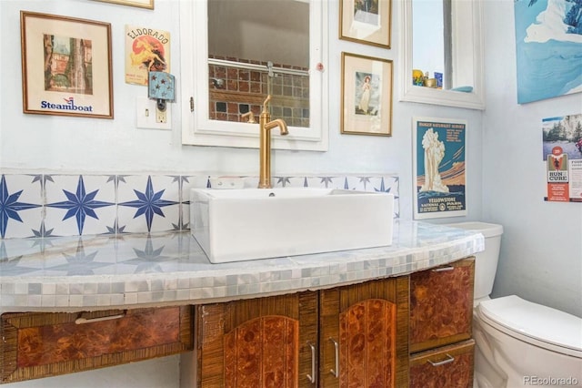 bathroom with toilet and vanity