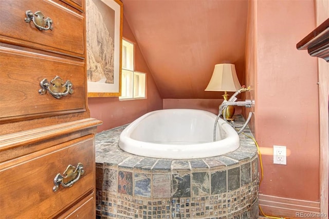 full bath with tiled tub and vaulted ceiling