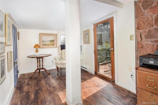 interior space with a baseboard radiator, baseboards, and hardwood / wood-style floors