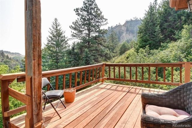 wooden terrace with a wooded view