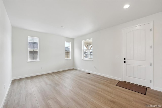 empty room with light hardwood / wood-style floors