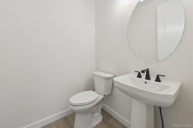 bathroom featuring hardwood / wood-style floors, sink, and toilet