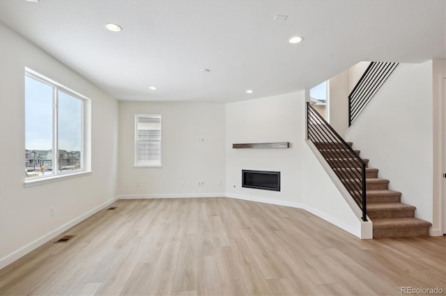 unfurnished living room featuring light wood-type flooring