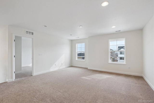 empty room featuring light carpet