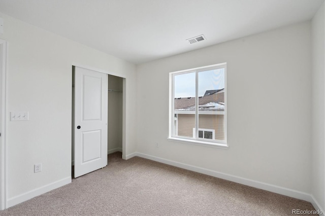 unfurnished bedroom with carpet and a closet