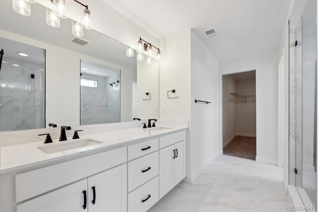 bathroom with an enclosed shower and vanity