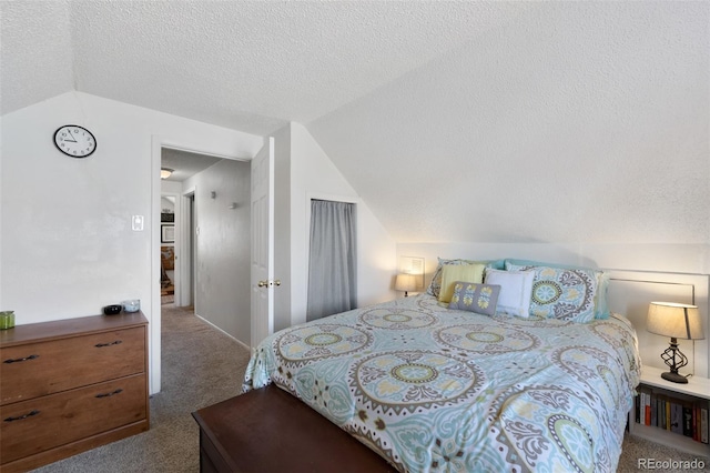 carpeted bedroom with a textured ceiling and vaulted ceiling