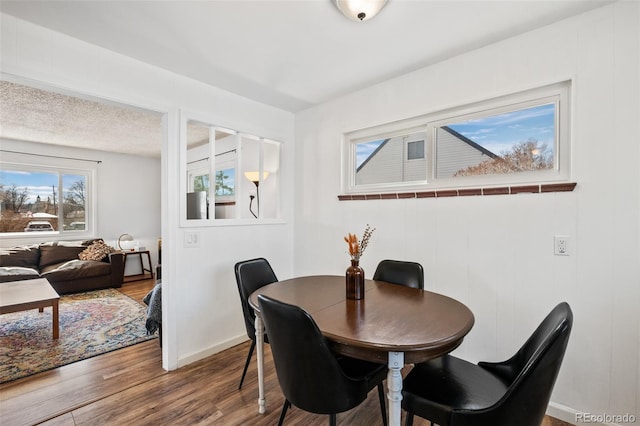 dining room featuring wood finished floors and baseboards