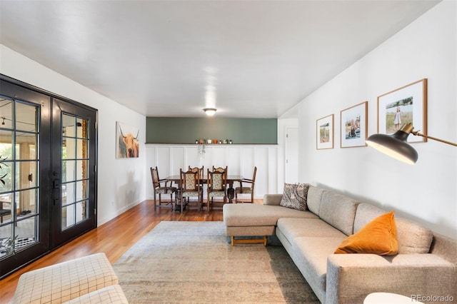 living room featuring wood-type flooring and french doors