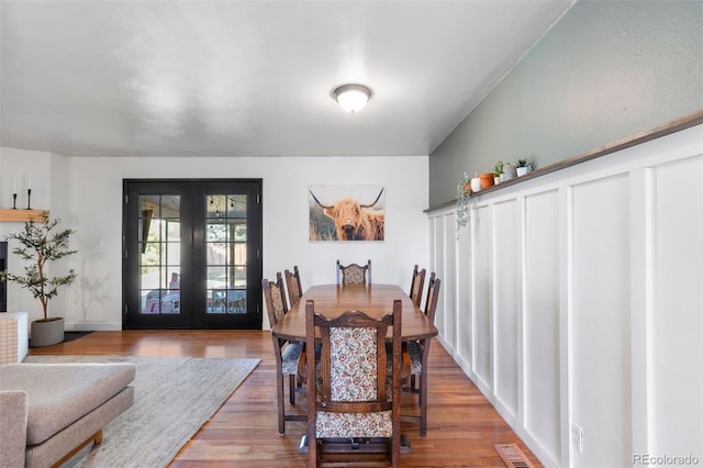 dining room with french doors and wood-type flooring