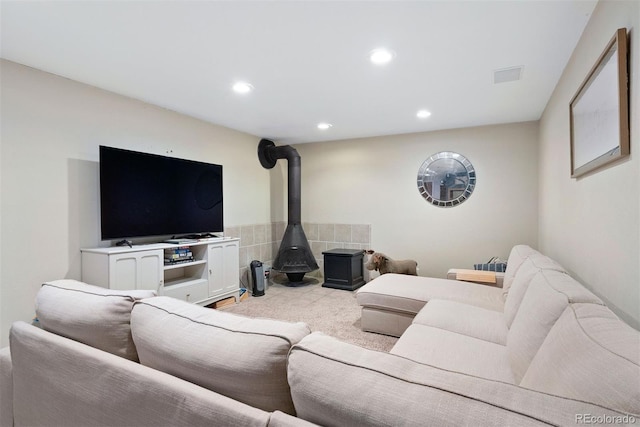 carpeted living room featuring a wood stove