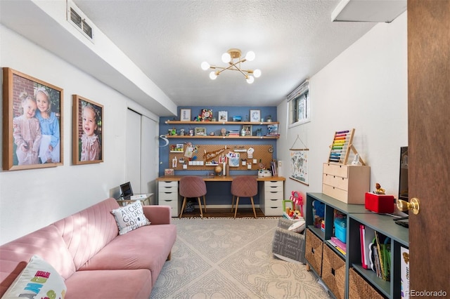 office featuring an inviting chandelier and a textured ceiling