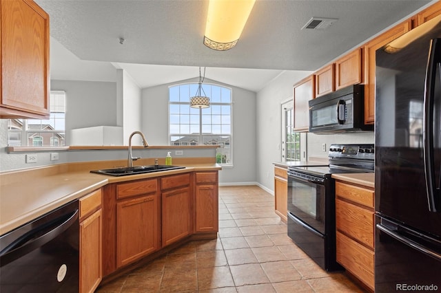 7440 S Blackhawk St Unit 207, Englewood, CO 80112 - kitchen with black appliances, vaulted ceiling, light countertops, and healthy amount of natural light
