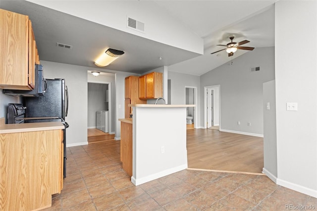 7440 S Blackhawk St Unit 207, Englewood, CO 80112 - kitchen featuring black range with electric cooktop, a ceiling fan, lofted ceiling, light countertops, and a peninsula