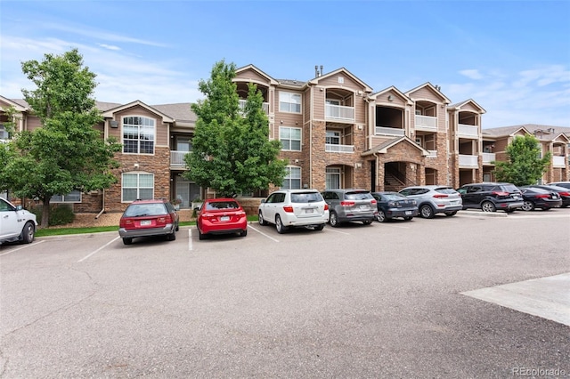 7440 S Blackhawk St Unit 207, Englewood, CO 80112 - view of building exterior with uncovered parking
