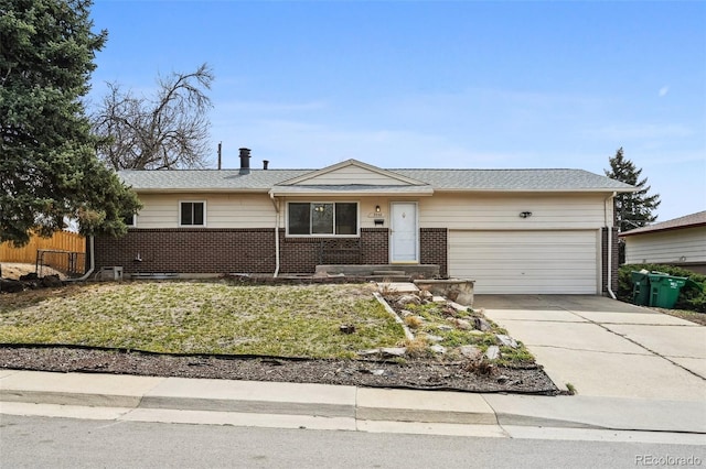 single story home featuring a garage, brick siding, concrete driveway, and fence