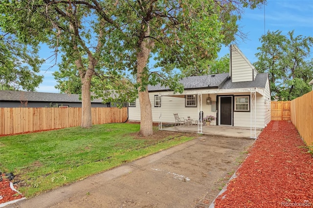1325 Dayton St, Aurora, CO 80010 - view of front of property with a fenced backyard, a patio area, and roof with shingles