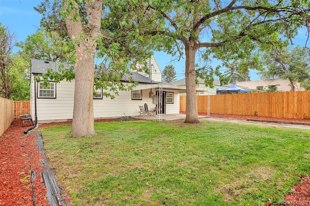 1325 Dayton St, Aurora, CO 80010 - rear view of property with a patio and a fenced backyard