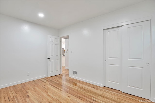 1325 Dayton St, Aurora, CO 80010 - unfurnished bedroom with light wood-style flooring, recessed lighting, and a closet