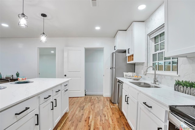 1325 Dayton St, Aurora, CO 80010 - kitchen with decorative light fixtures, white cabinetry, backsplash, light stone countertops, and recessed lighting