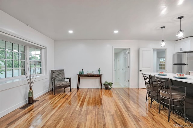1325 Dayton St, Aurora, CO 80010 - living area featuring light wood finished floors and recessed lighting