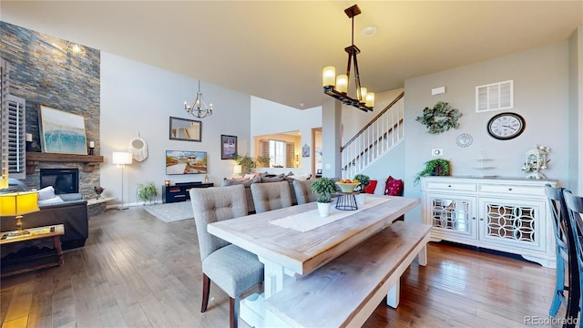 dining space with hardwood / wood-style flooring and a fireplace