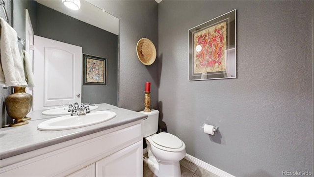 bathroom featuring vanity, tile patterned flooring, and toilet