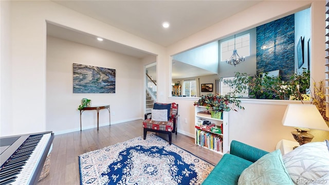 living area with hardwood / wood-style floors and a chandelier