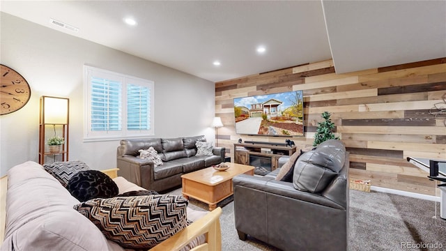 living room featuring carpet flooring and wood walls