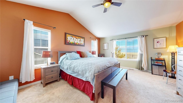 carpeted bedroom with ceiling fan and vaulted ceiling