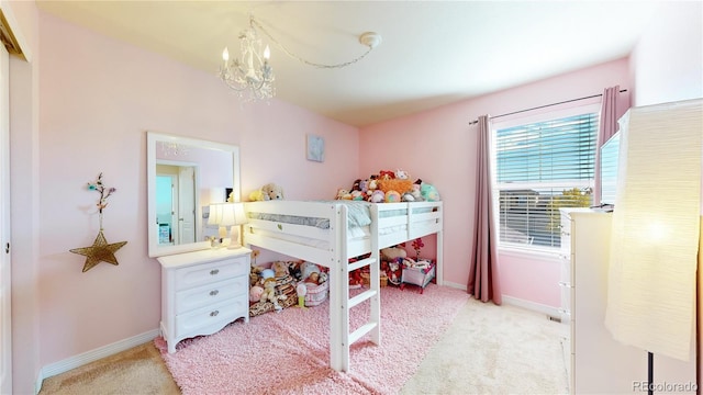 bedroom with light colored carpet and a chandelier