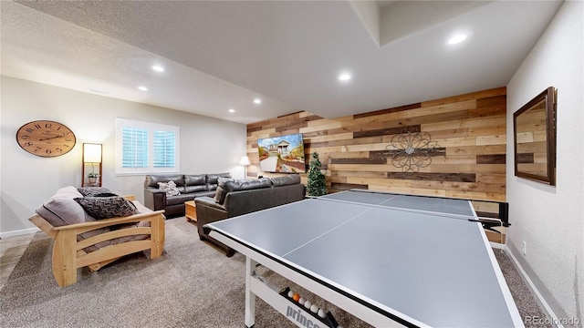 playroom featuring carpet flooring and wood walls