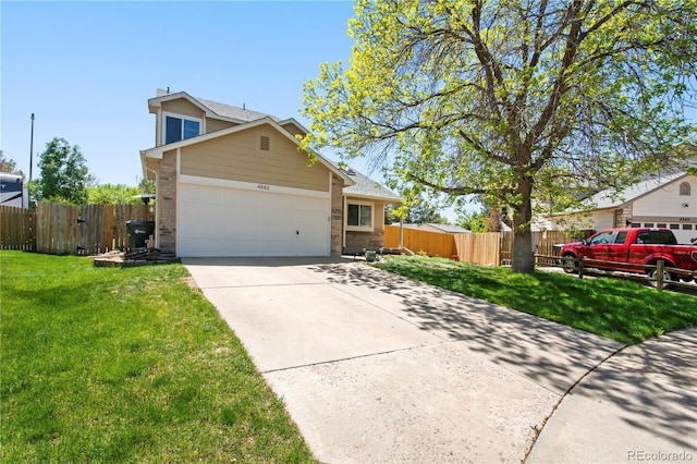 view of front of home with brick siding, an attached garage, fence, and a front yard