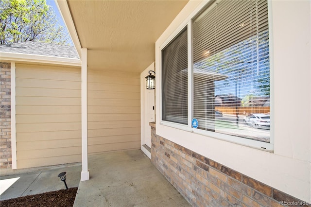 property entrance featuring brick siding