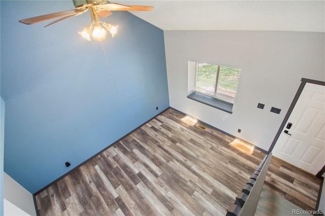 unfurnished living room featuring ceiling fan, wood finished floors, and lofted ceiling