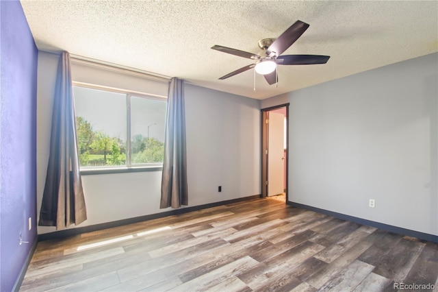 unfurnished room featuring baseboards, a textured ceiling, ceiling fan, and wood finished floors