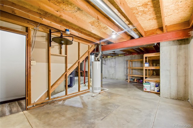 unfinished below grade area featuring water heater
