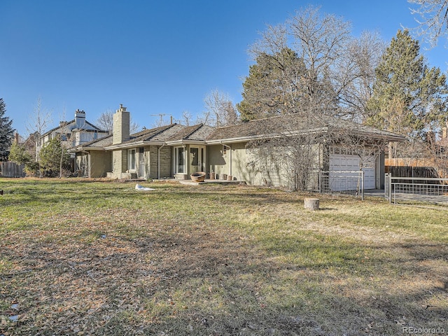 view of front of home with a garage and a front lawn