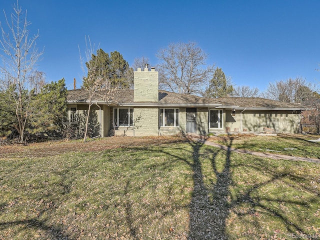 back of property featuring a yard