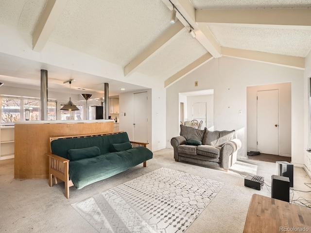 carpeted living room featuring vaulted ceiling with beams and a textured ceiling