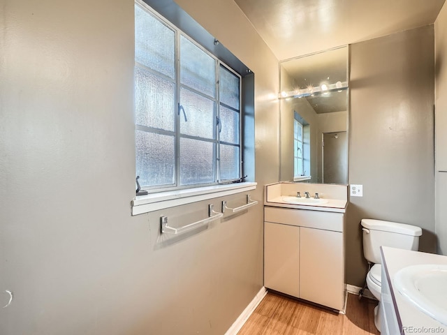 bathroom featuring hardwood / wood-style floors, vanity, and toilet